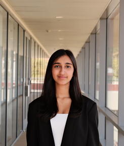 headshot of student in glass hallway