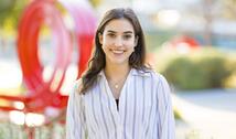Celine Bernhardt-Lanier ’26 photographed in front of the red Jeppe Hein benches on campus.